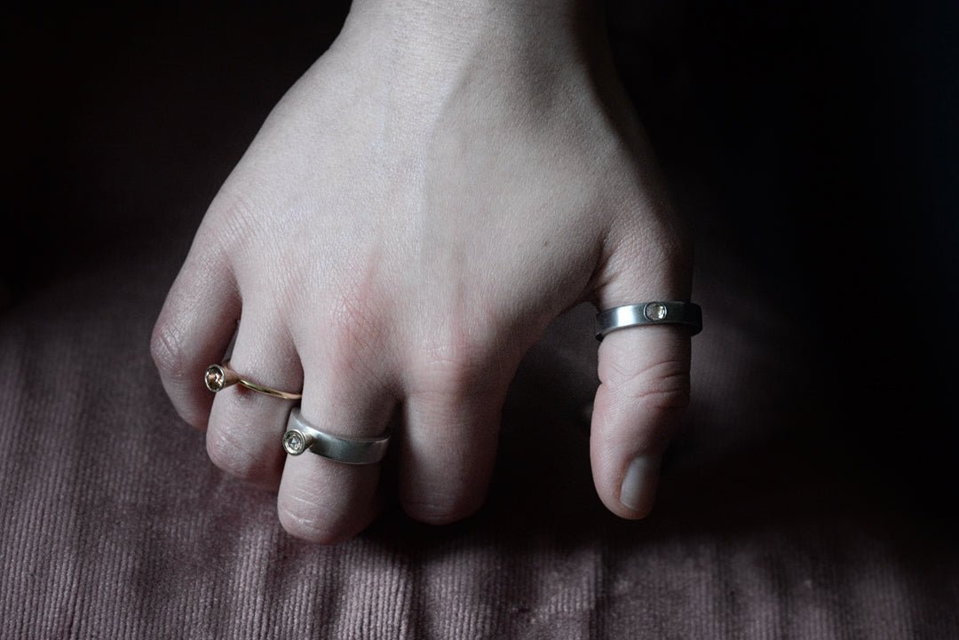 Diamond-set bands in gold and silver, on the hand