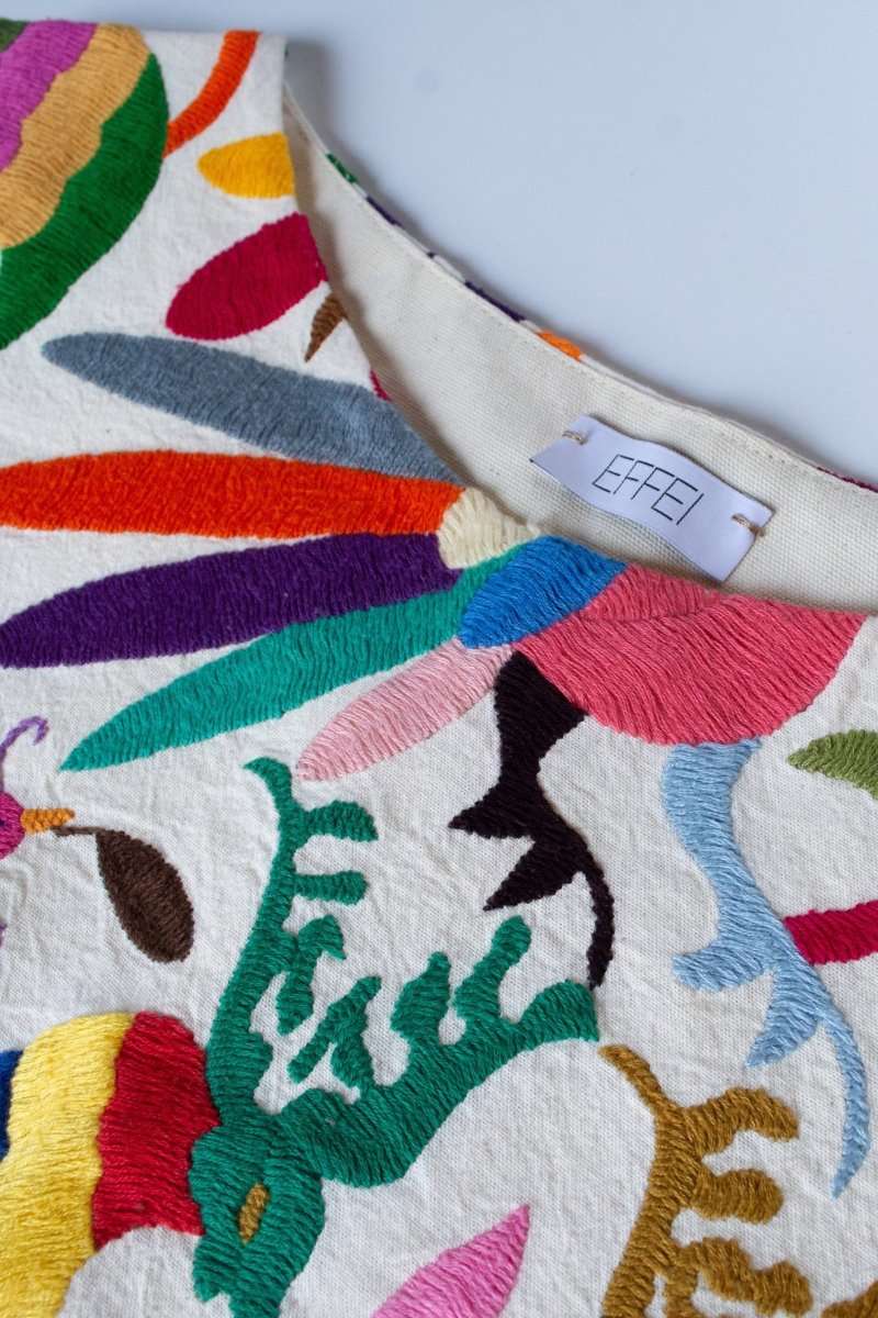 Otomí embroidery on the vest, stitched by hand in Mexico