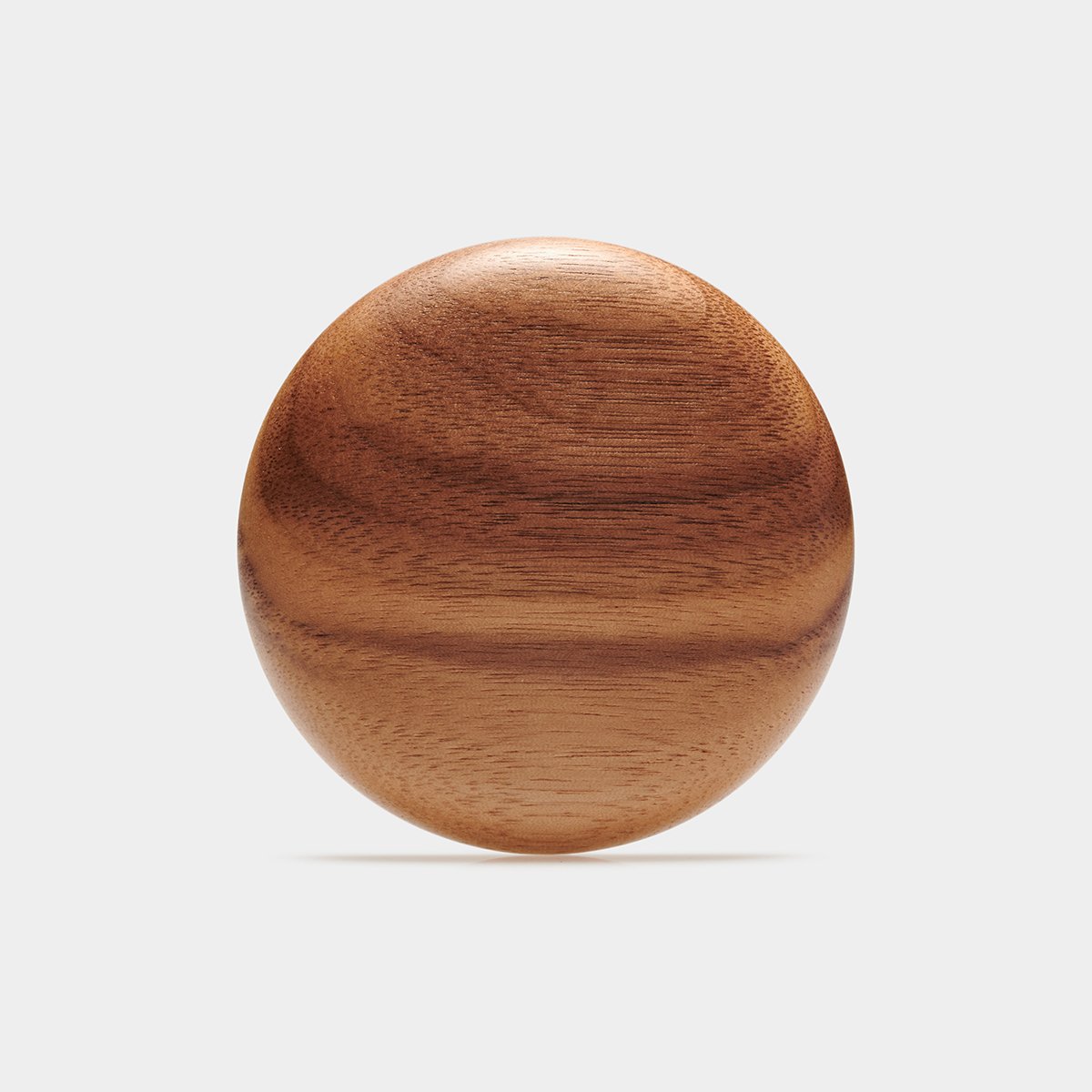 Laura's Mirror, a round pocket mirror turned from walnut, shown closed on a pale background