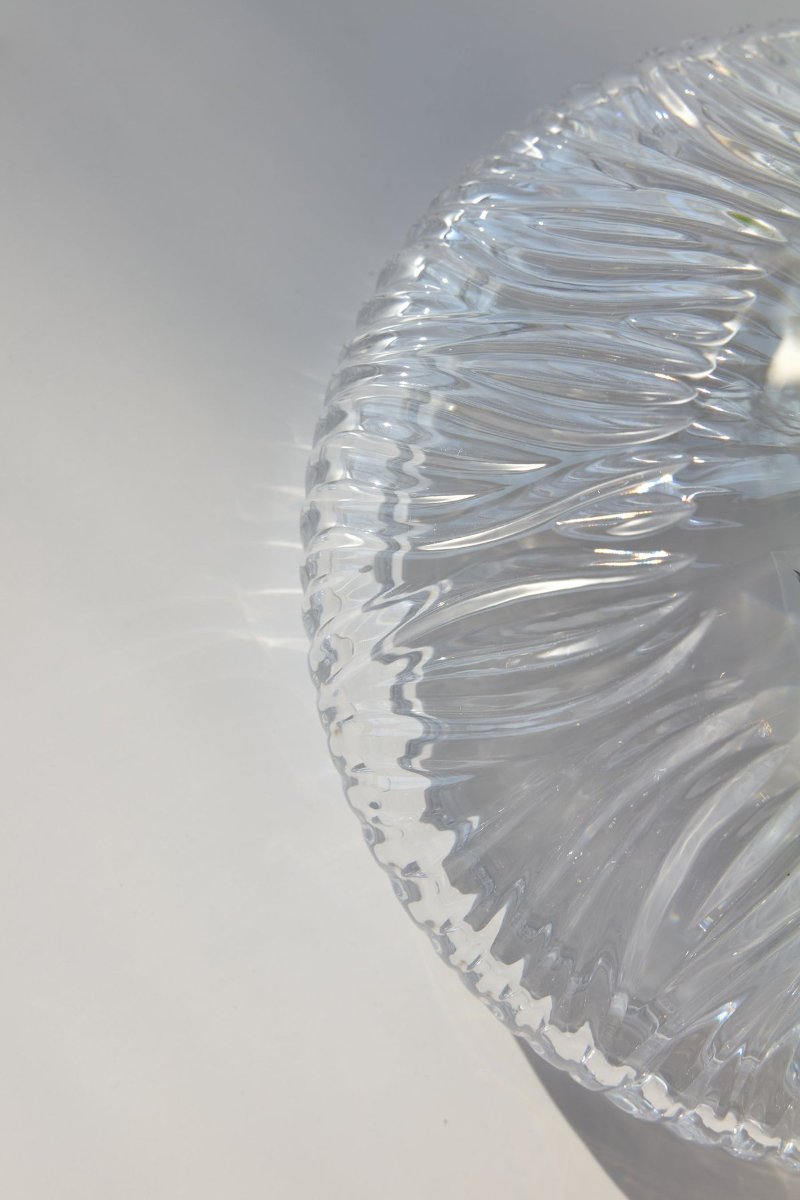 Clear crystal cut close with fanned grooves, the light breaking along every edge