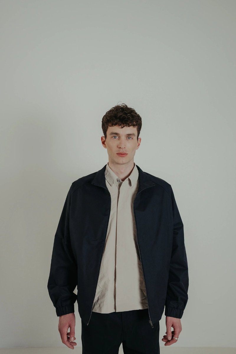The blouson in dark navy, cut from the Italian nylon.