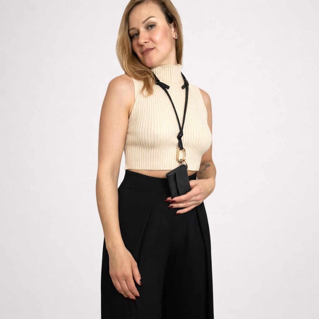 The mini wallet, worn as a crossbody or a necklace.