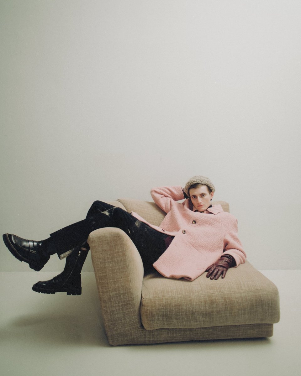 A pink wool jacket, leather gloves, and an armchair to lie back into.
