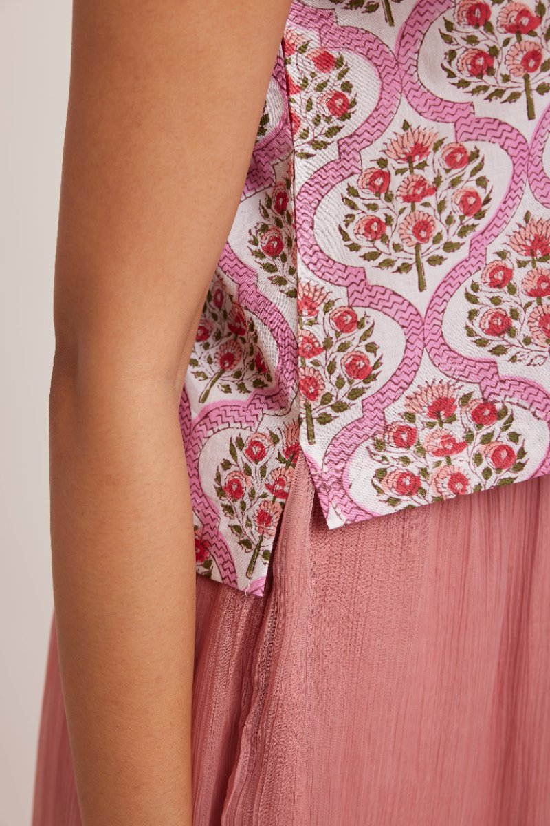 A pink hand block print on the GOLBAHAR top, seen close up