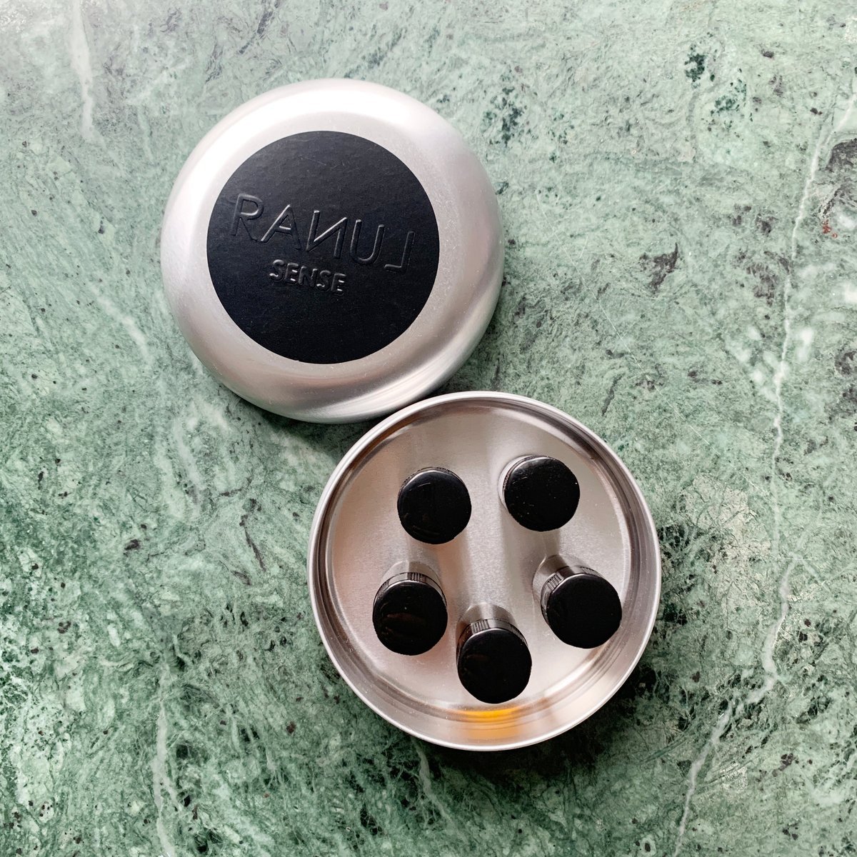 Five two-millilitre vials in their tin, the lid lying open beside it