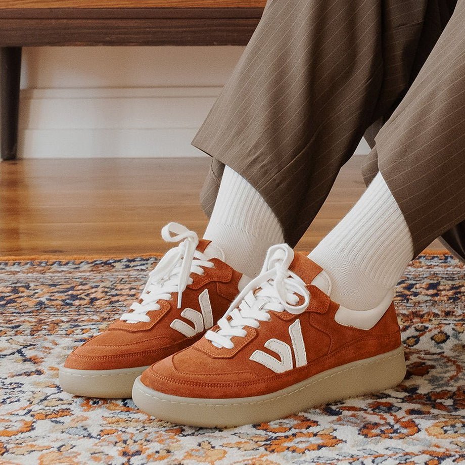 The Misfit sneaker in terracotta suede, worn