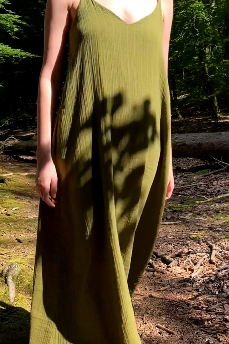 The olive muslin dress, floor length with a low back and a bow.