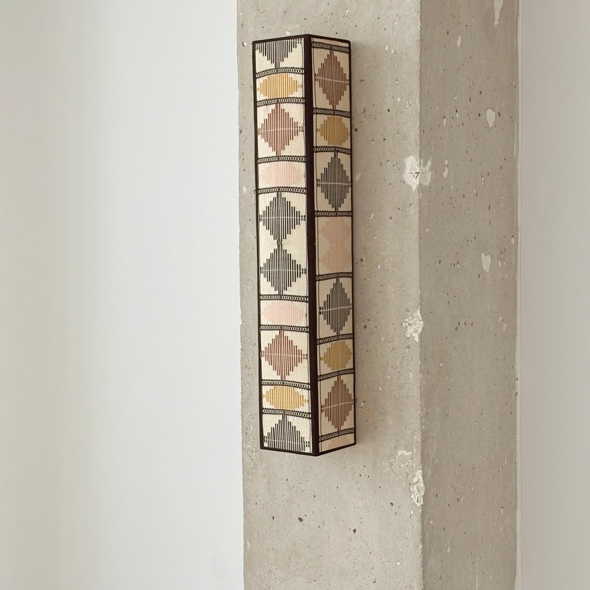 The Loom wall sconce, two days of Kente weaving.