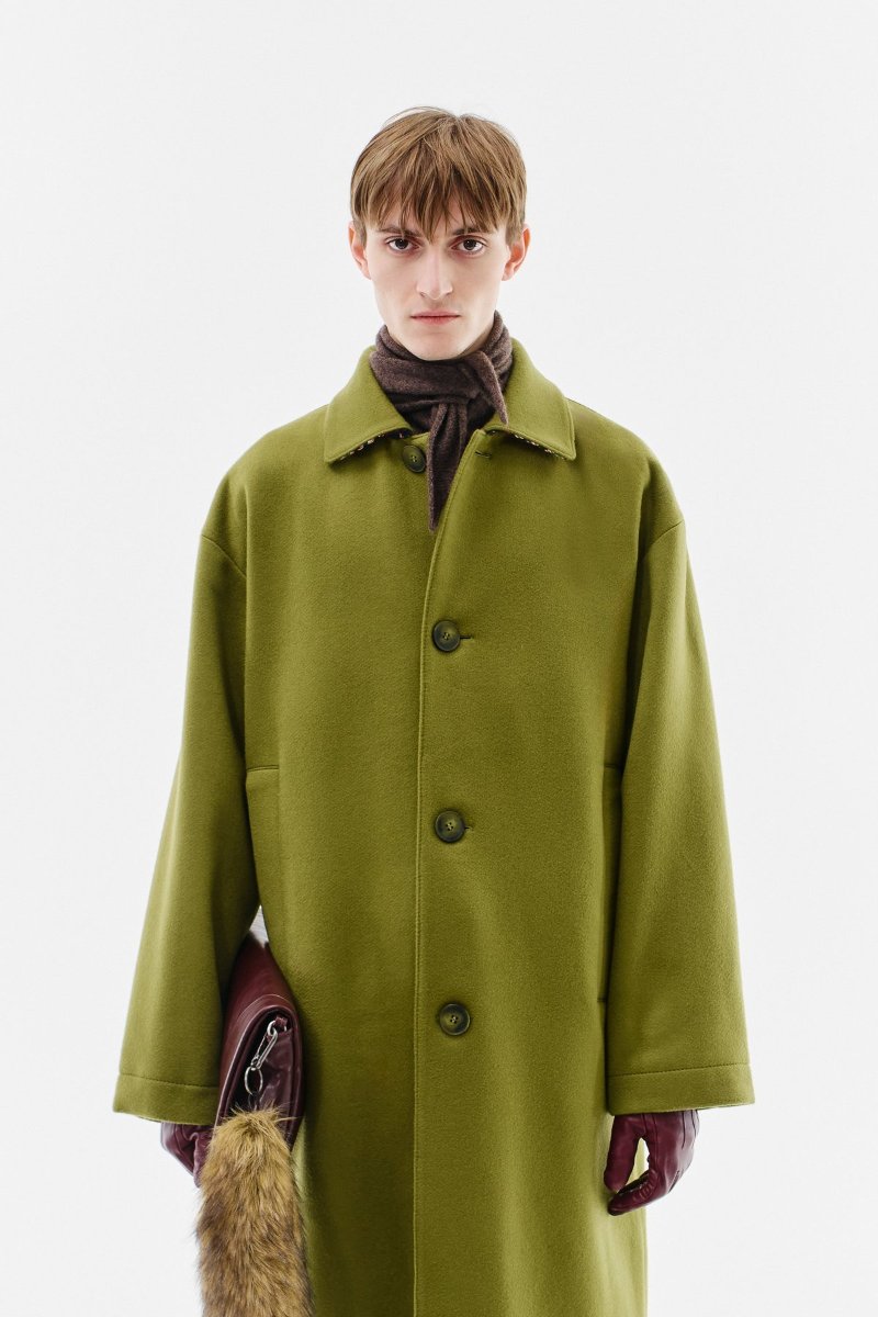 The cashmere coat in olive, shoulders dropped, sleeves wide.