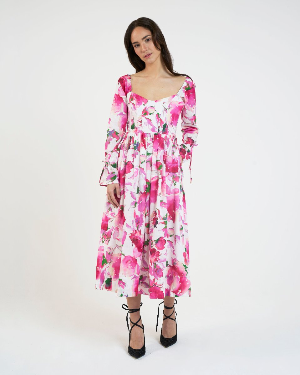 THE PINK BLOOM DRESS from the front with the long sleeves buttoned on, the sleeve ties visible at the wrists.