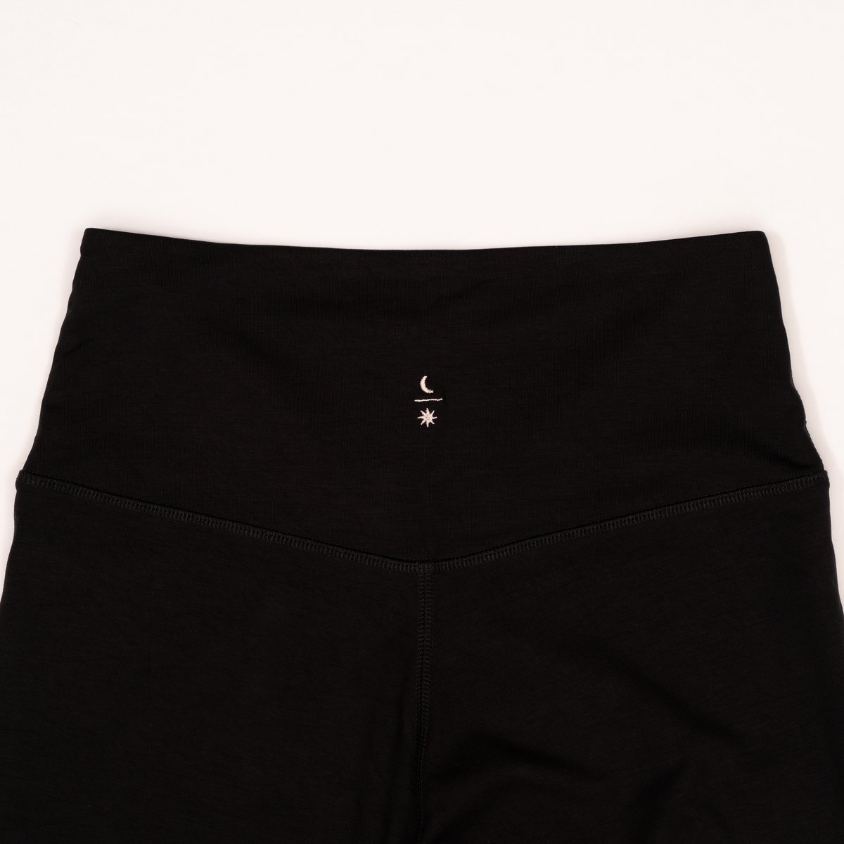 The leggings waistband, cut from the same cloth, sun and moon embroidered small
